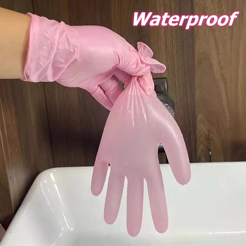 A hand wearing a pink waterproof disposable glove is shown above a white sink.