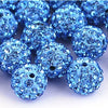 A pile of small, round, blue crystal clay beads used for DIY jewelry and craft projects.