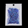 A clear plastic bag filled with mixed blue and purple glass seed beads for jewelry making
