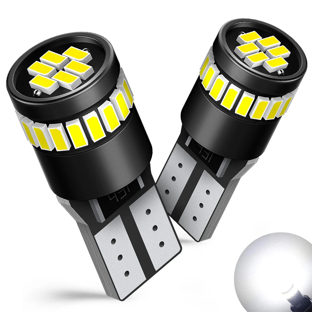 A pair of black LED light bulbs with yellow illumination and a silver base are shown.