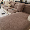 A cozy brown jacquard fleece sofa cover with anti-slip backing and decorative pillows.