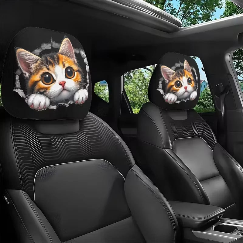 A pair of cat-themed headrest covers featuring cute feline faces placed in a car interior.