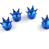 A set of four shiny blue universal crown valve caps displayed on a white background.