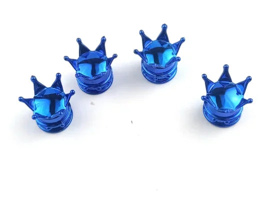 A set of four shiny blue universal crown valve caps displayed on a white background.