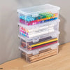 Clear plastic storage boxes with lids containing various colored pencils and pens for office or craft use