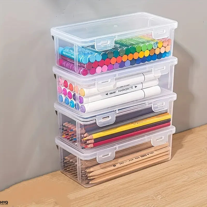 Clear plastic storage boxes with lids containing various colored pencils and pens for office or craft use