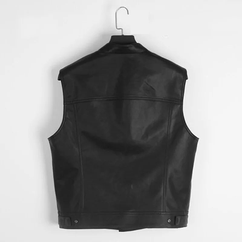 Black faux leather biker vest with a collar hanging on a hook.
