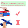 A hand is placing a red foam airplane head onto a radiator, demonstrating correct installation for an outdoor toy.