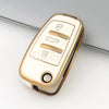 A close-up view of a white and gold protective TPU key fob cover for an Audi flip key.
