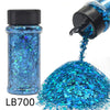 A bottle of LB700 holographic blue glitter nail mix with a black shaker top and loose glitter spilling out.