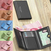 A black leather card holder wallet is shown open, displaying multiple slots and a passport or ID document.