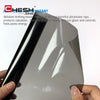 A hand holds a premium car window tint film, showing its glossy surface and protective layer.