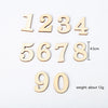 A set of wooden numbers 1 through 90 for a Montessori busy board fine motor skills activity.