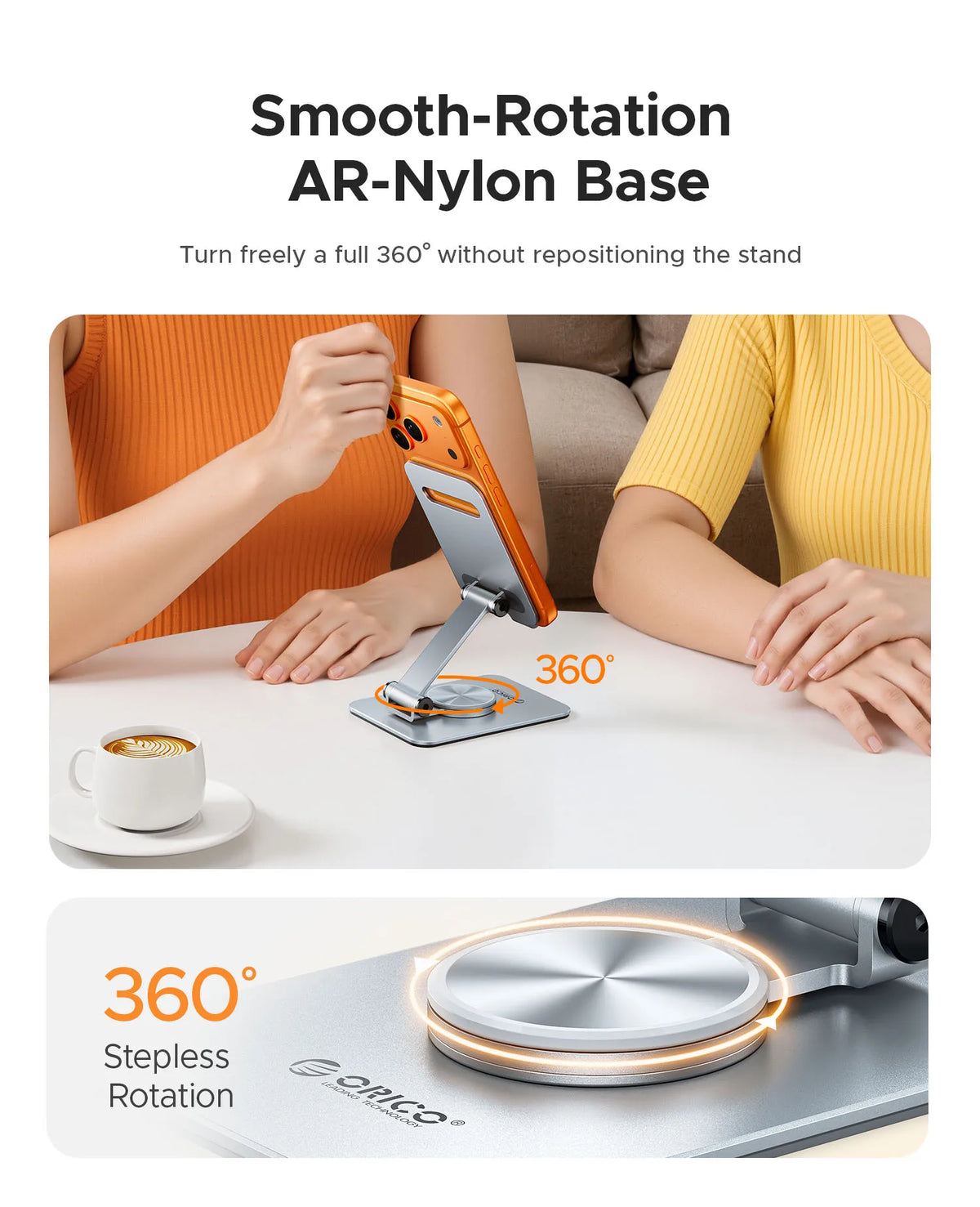 An orange-colored hand holds an orange phone resting on a smooth, silver aluminum base for 360 degree rotation.