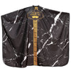 Black waterproof barber gown or cape with gold trim and a decorative label
