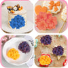 A set of 3D floral silicone molds in various colors including blue, orange, and purple for crafting.