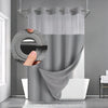A hand is holding a round shower curtain with a dotted waffle weave texture, demonstrating the snap-in liner.