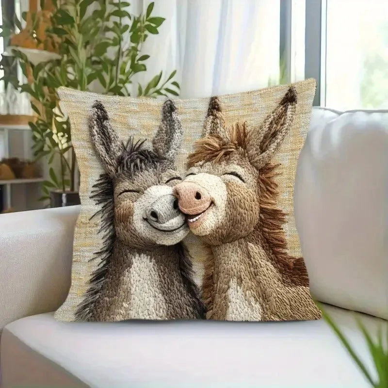 A decorative pillow featuring a realistic cartoon depiction of two adorable donkeys.