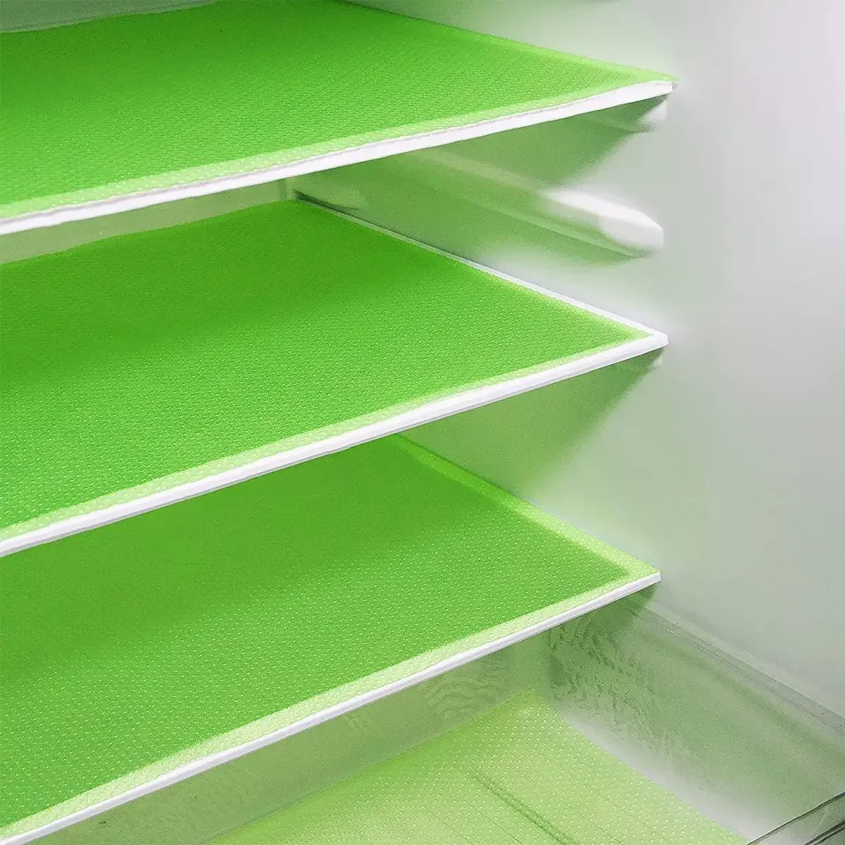 Three stacked bright green EVA refrigerator shelf liners with white edges.
