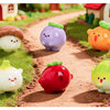 A collection of hand-painted resin vegetable figurines, including a purple eggplant, orange squash, red apple, and green squa