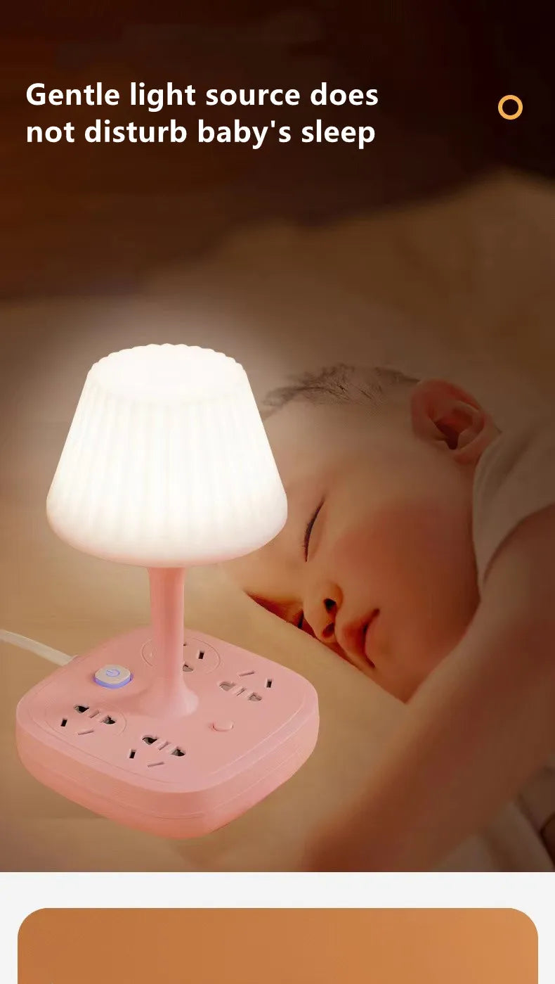 A pink LED night light lamp is placed next to a sleeping baby's head.