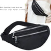 Black multi functional trendy waist bag with a zipper and adjustable strap shown against a white garment.