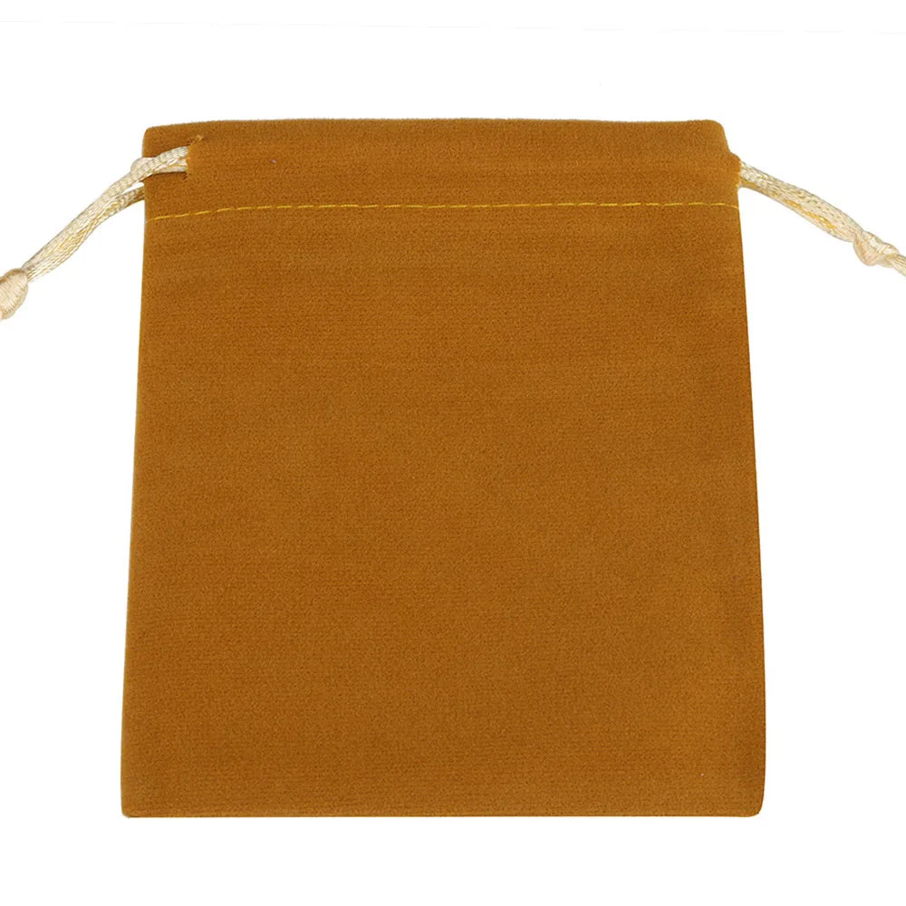A rectangular, mustard-colored velvet drawstring pouch with light beige string ties.