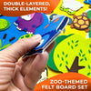 A hand holds a double-layered, thick felt element featuring a blue and white animal design from a zoo-themed felt board set.