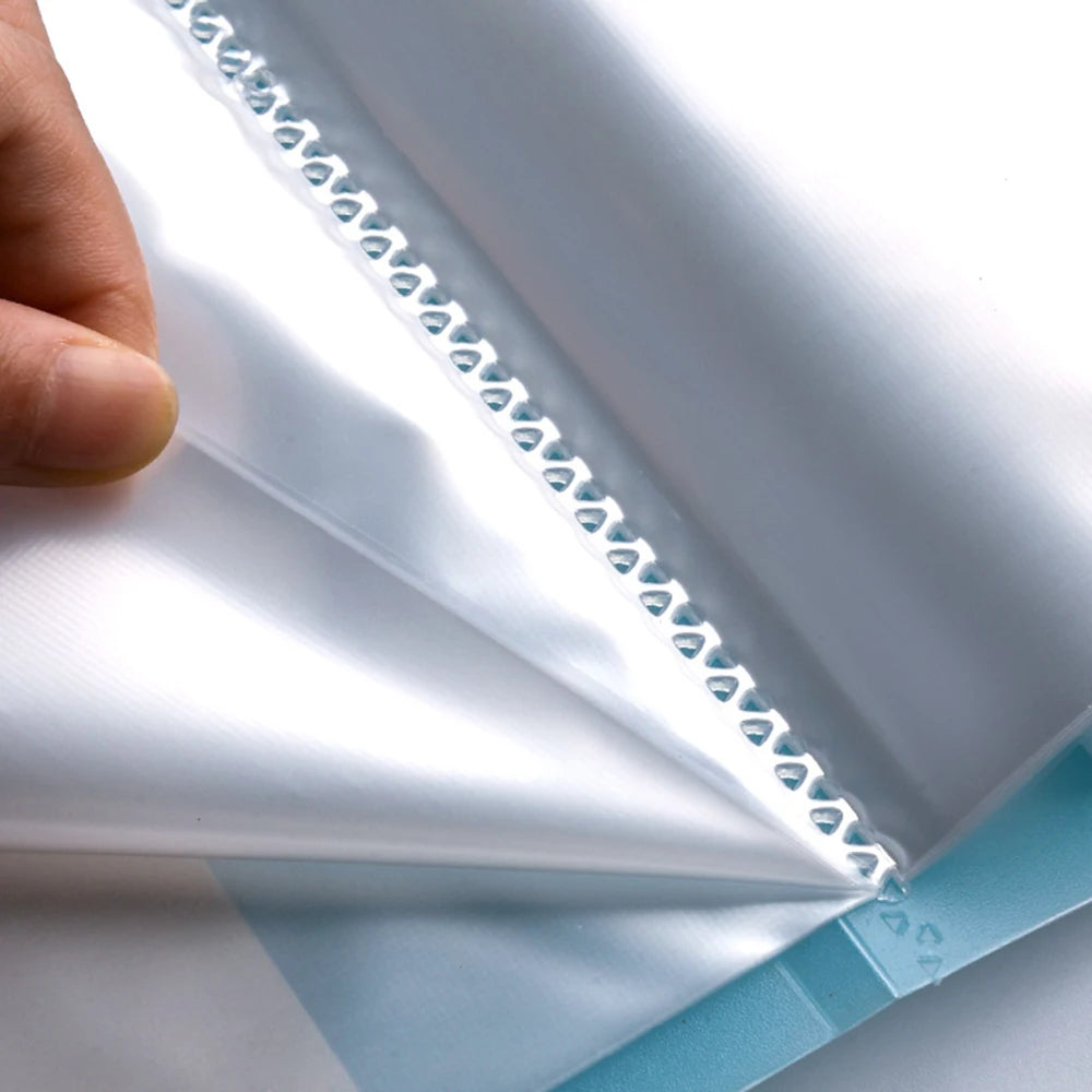 A close-up of a diamond painting storage book with clear pockets, showing the white and light blue fabric covers.