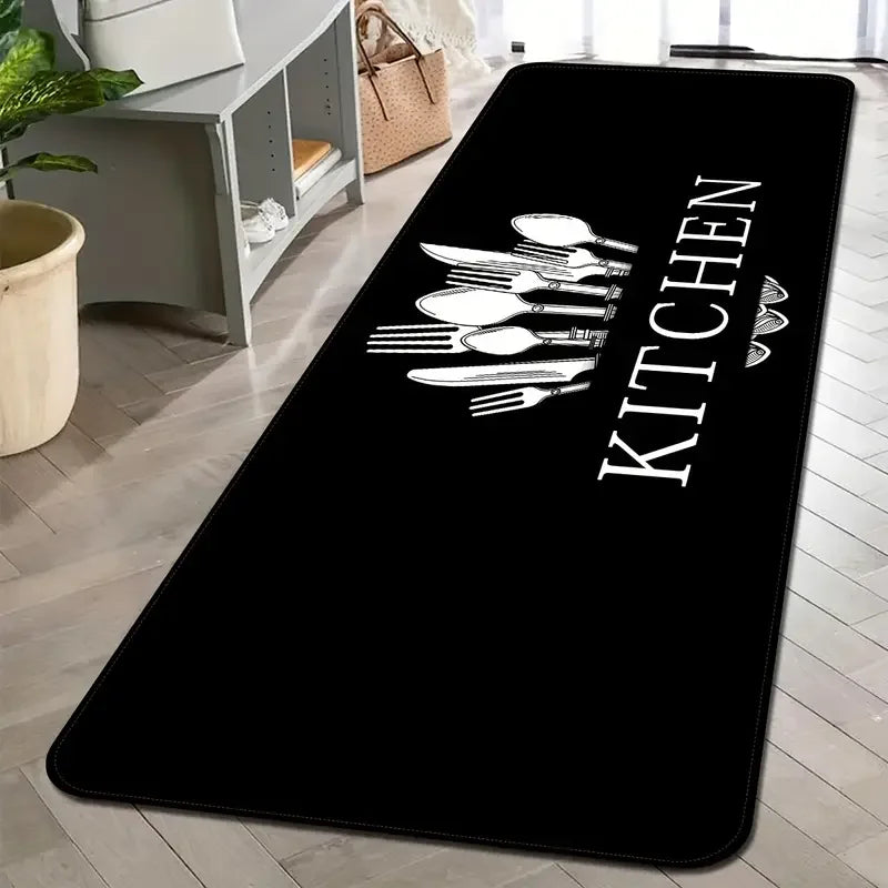 Black non-slip kitchen mat with white cutlery design on a light wooden floor.