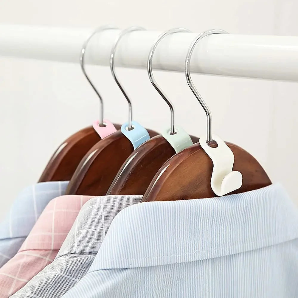 A set of cascading clothes hanger connector hooks with colored plastic grips hanging from a white rod.