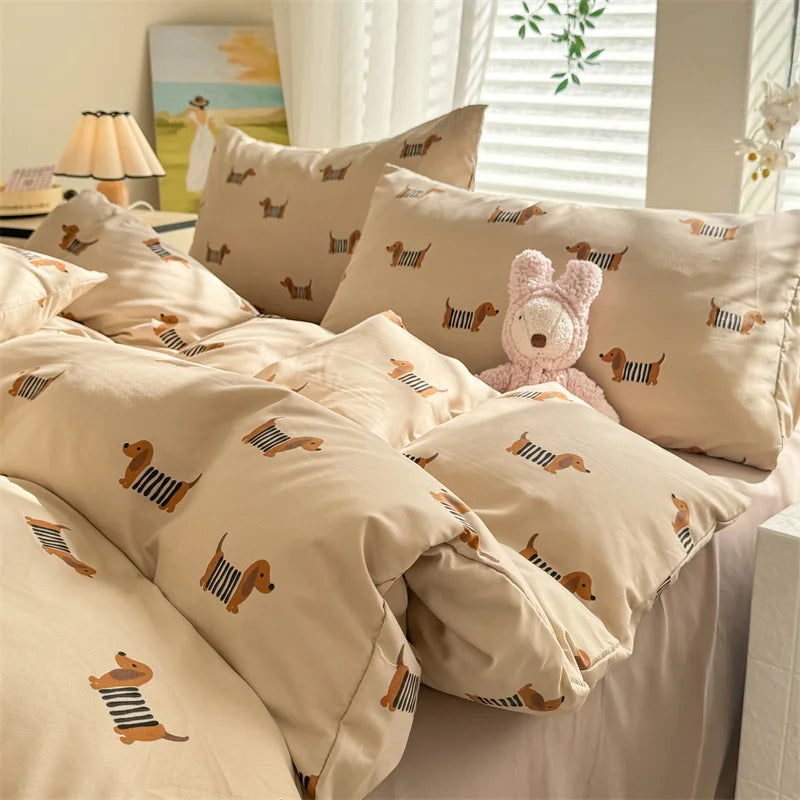 A set of beige duvet cover and pillowcases featuring a cute dog print design.