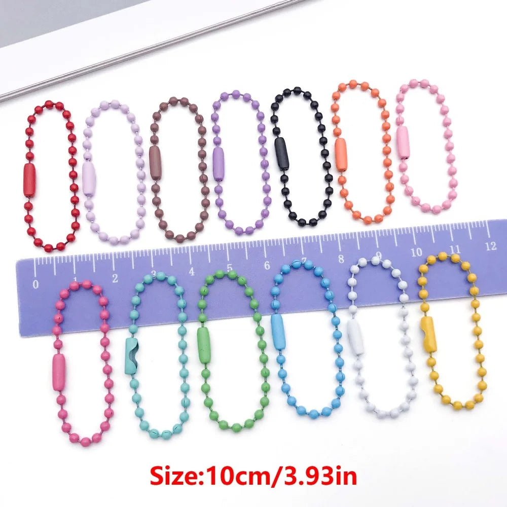 A collection of 50 colorful ball bead chains in various colors and sizes displayed next to a ruler.