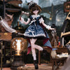 A detailed 1/6 BJD blind box doll with dark hair and glasses dressed in a blue and white outfit, set in a miniature steampunk