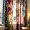Two colorful boho ethnic patchwork print curtains hanging in a bright room.