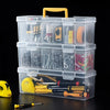 A clear plastic storage box with multiple compartments holds various tools and hardware items.