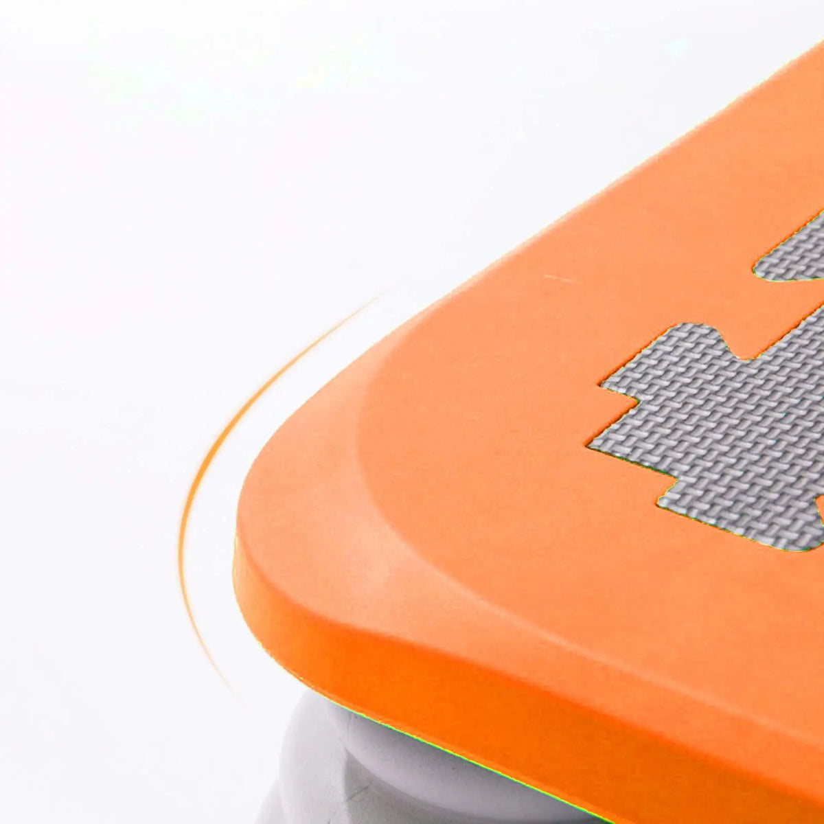 Orange kids mini trampoline with a silver bungee system visible from the side.