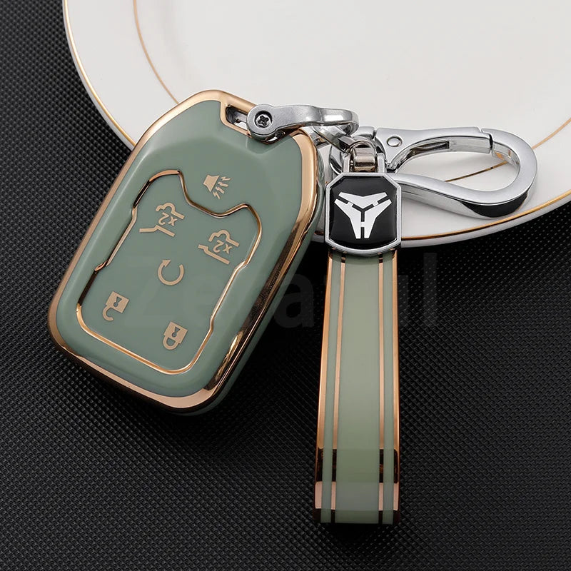 A transparent green TPU smart key fob cover with gold accents attached to a silver keychain.