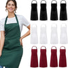 A woman models a set of two adjustable kitchen aprons in solid black and white colors.