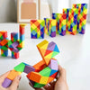 Hands holding a colorful, transformable fidget puzzle toy with geometric shapes.