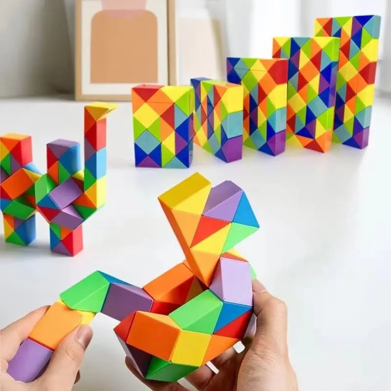 Hands holding a colorful, transformable fidget puzzle toy with geometric shapes.
