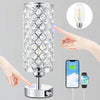 A clear crystal table lamp with a touch sensor and USB charging ports is shown, along with a hand interacting with the light.