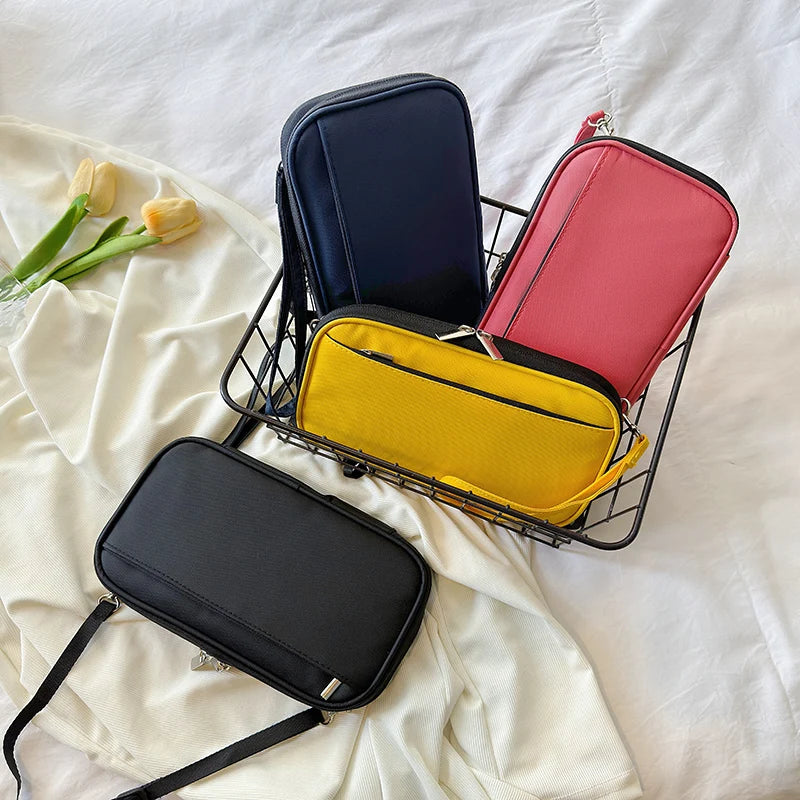 A black waterproof document organizer wallet and three colored passport holders are displayed on a white sheet.