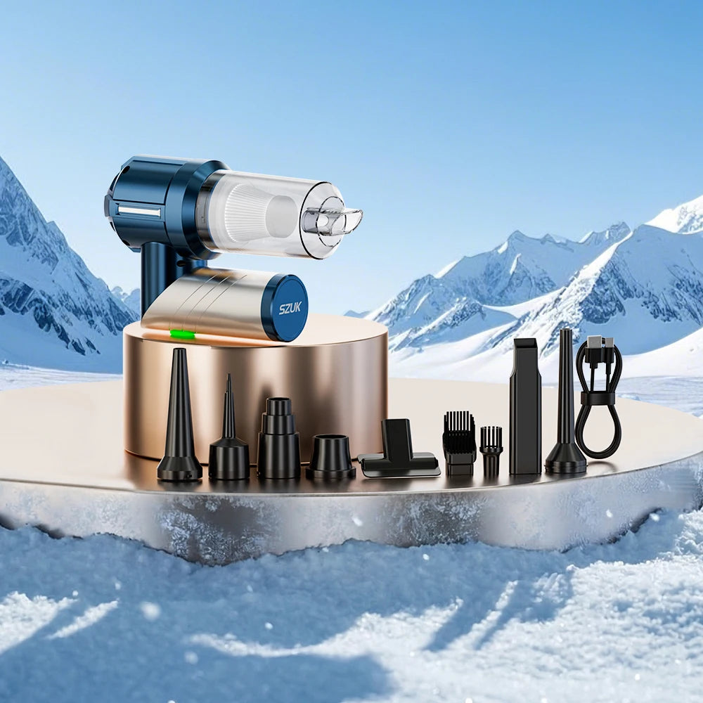 A foldable handheld car vacuum cleaner with various attachments resting on a metallic surface in a snowy outdoor setting.