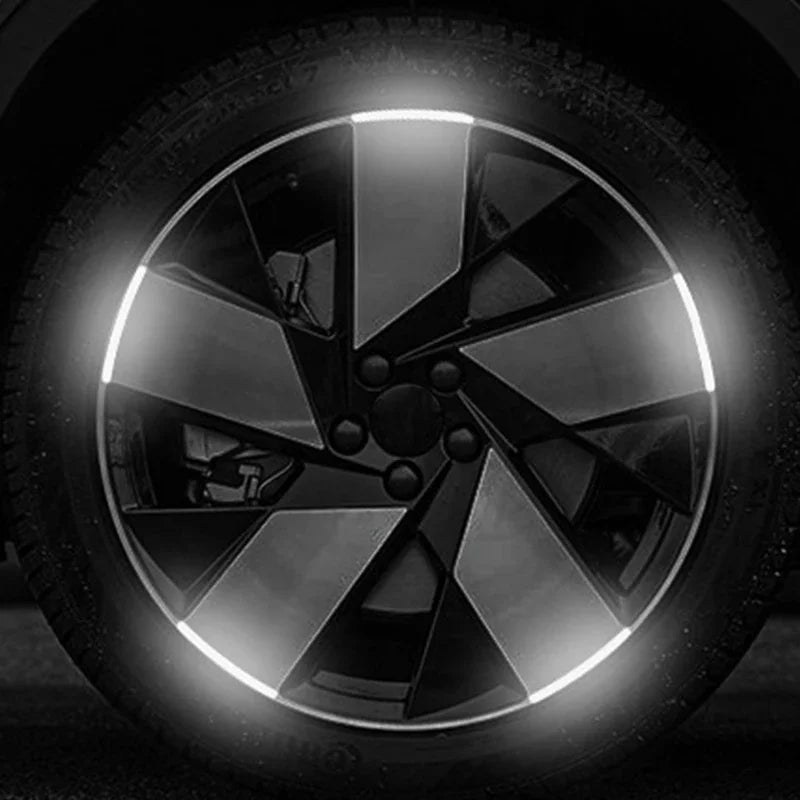 Close-up of a reflective wheel rim with geometric light strips.