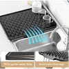 Silicone dish drying mat with automatic drainage features shown in a kitchen sink.