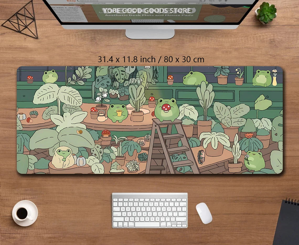 A large extended desk mat featuring a kawaii frog and nature design on a wooden surface.
