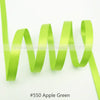 A bright apple green satin ribbon is shown coiled and unwound, demonstrating its texture and drape.