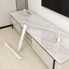 White marble peel-and-stick wallpaper shown on a modern cabinet surface.