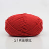 A ball of bright red 4-ply milk cotton yarn for knitting and crochet.